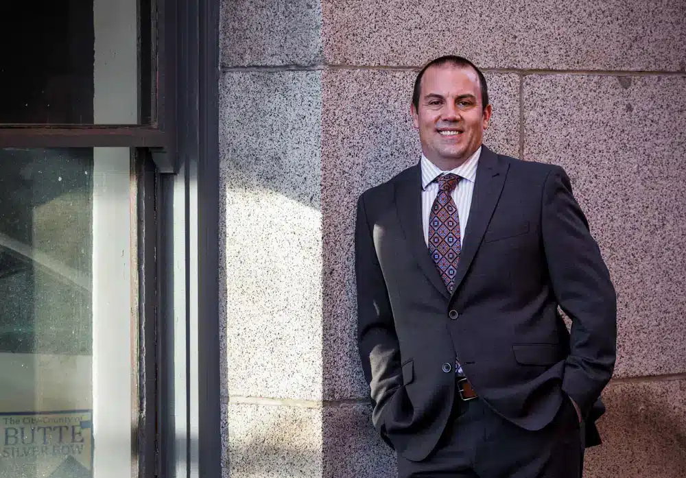Montana trucking accident attorney standing outside courthouse building representing injury victims