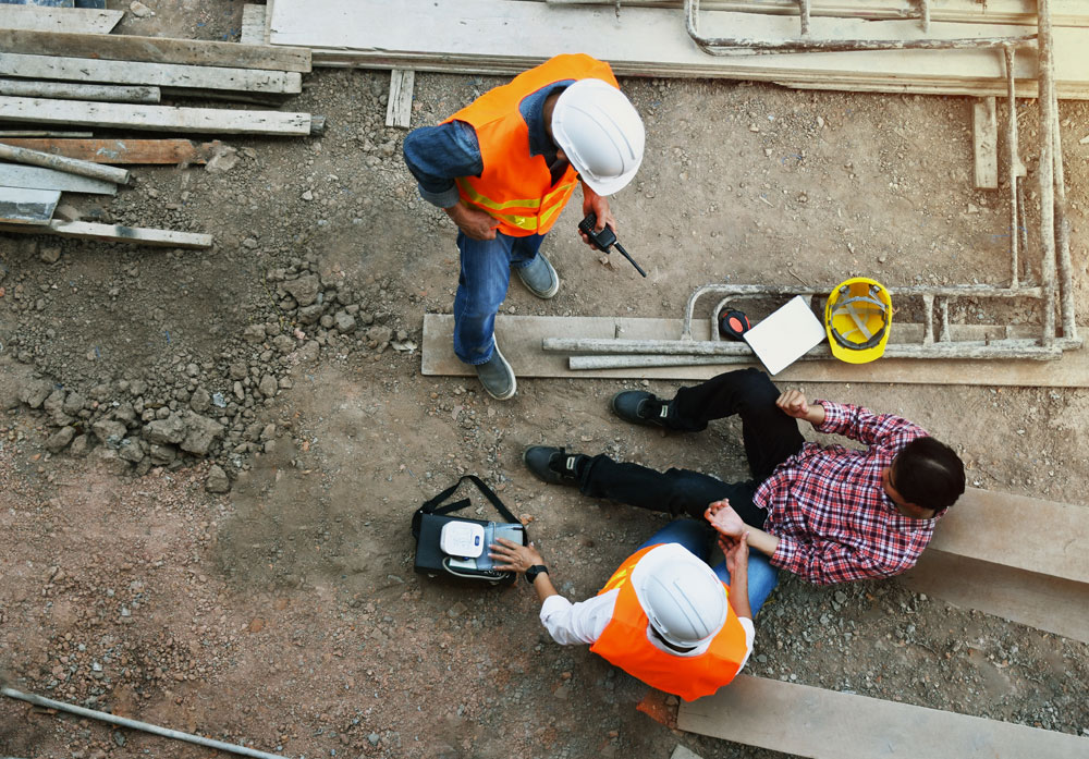 Injured worker receiving care at a construction site – representing industrial and construction accident cases in Montana.
